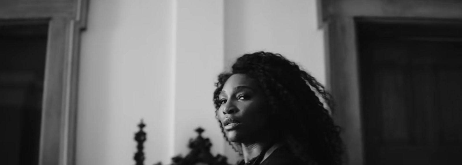 a black and white photo of a woman in a room