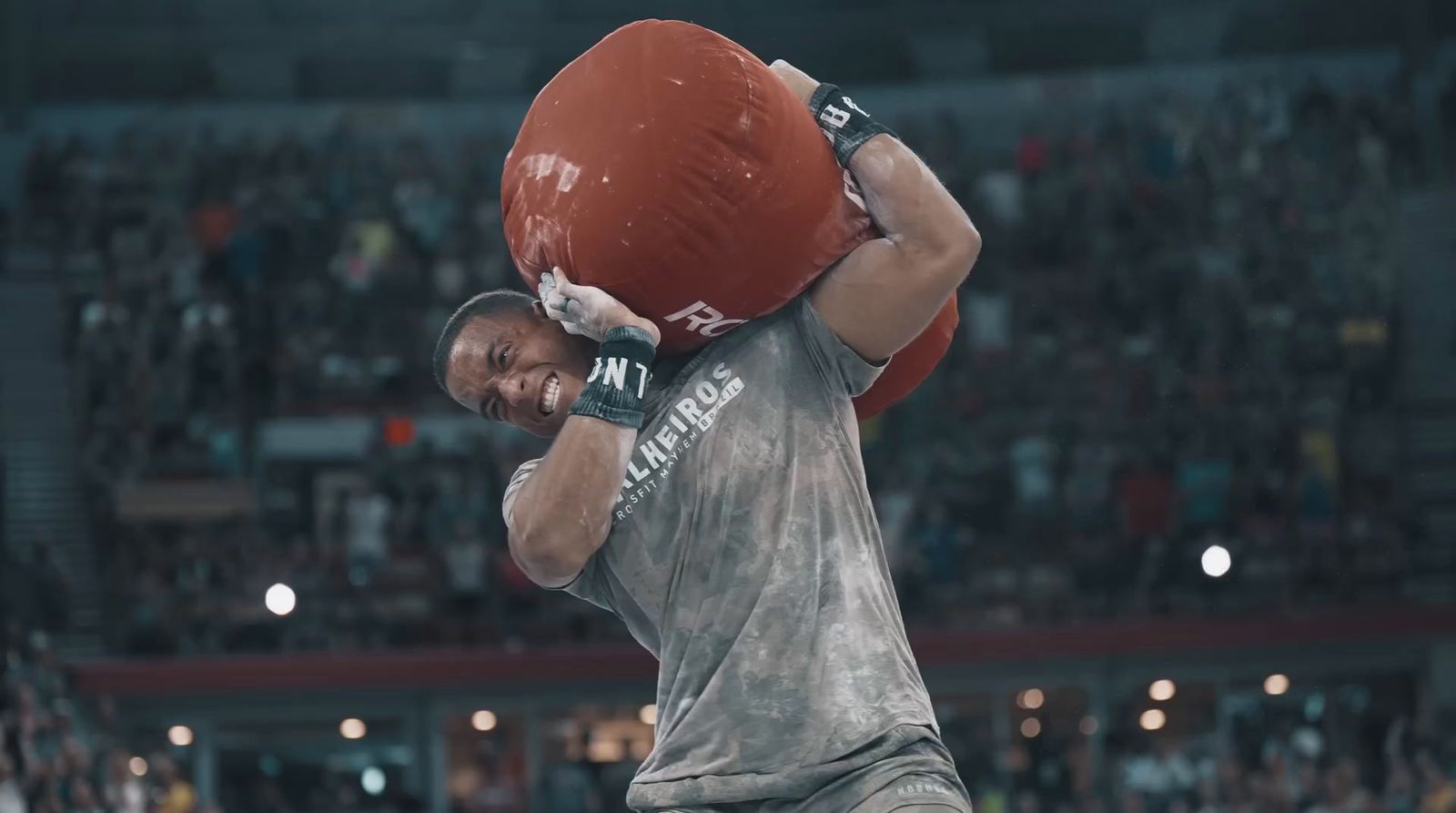 a man with a red ball on his head in front of a crowd