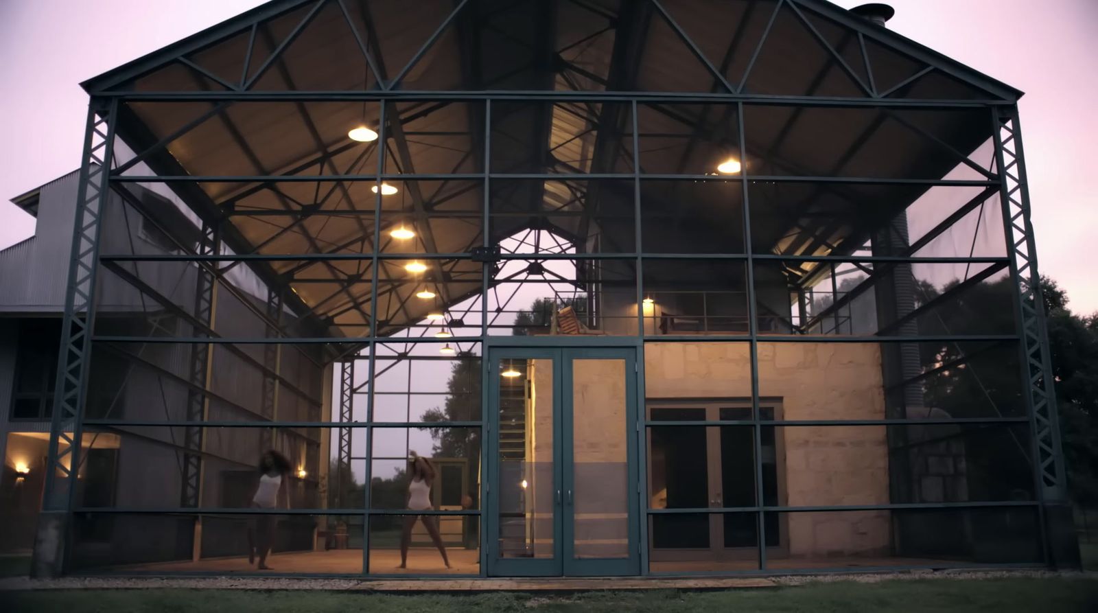 a large metal structure with people walking inside of it