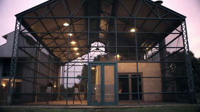 a large metal structure with people walking inside of it