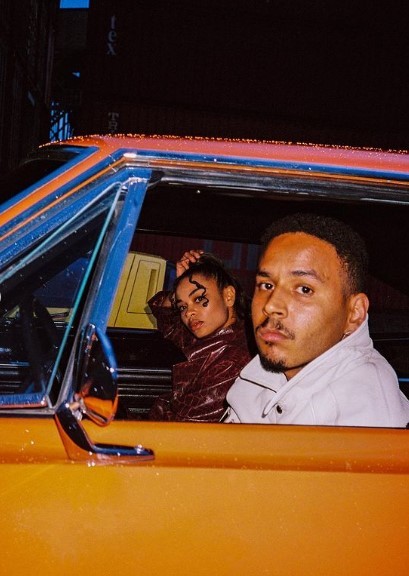 a man and a woman sitting in a car