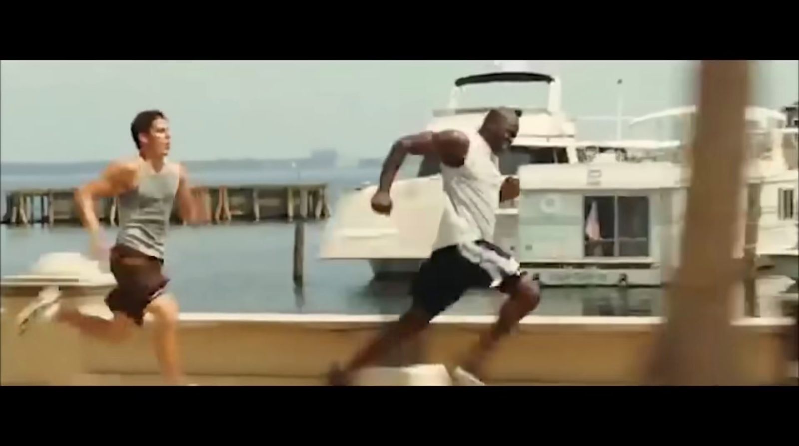 a couple of men running next to a boat