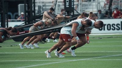 a group of people are running on a field