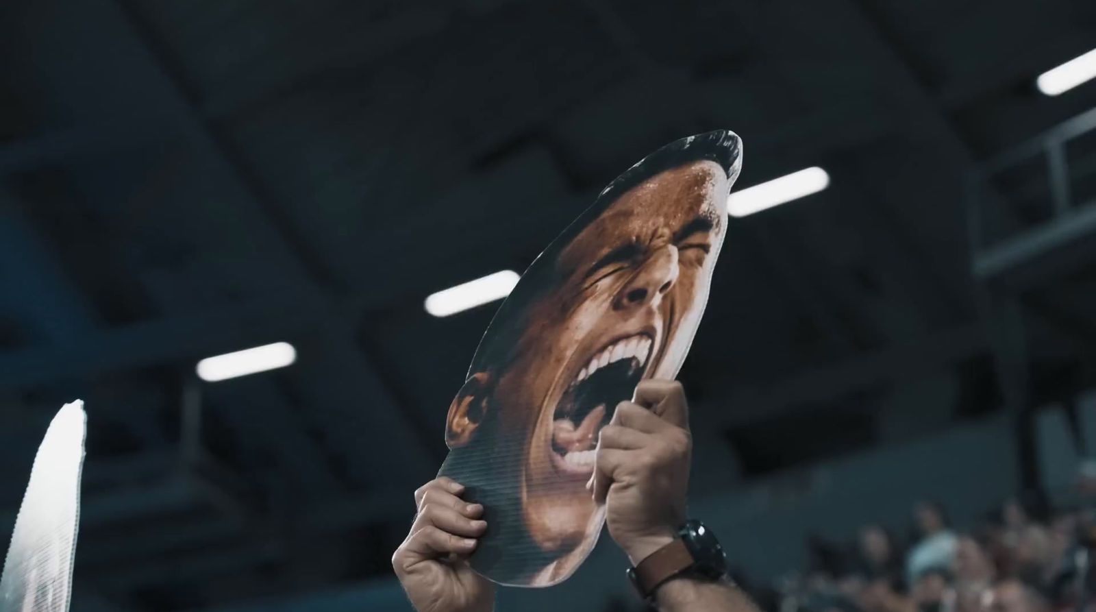 a man holding up a large picture of himself