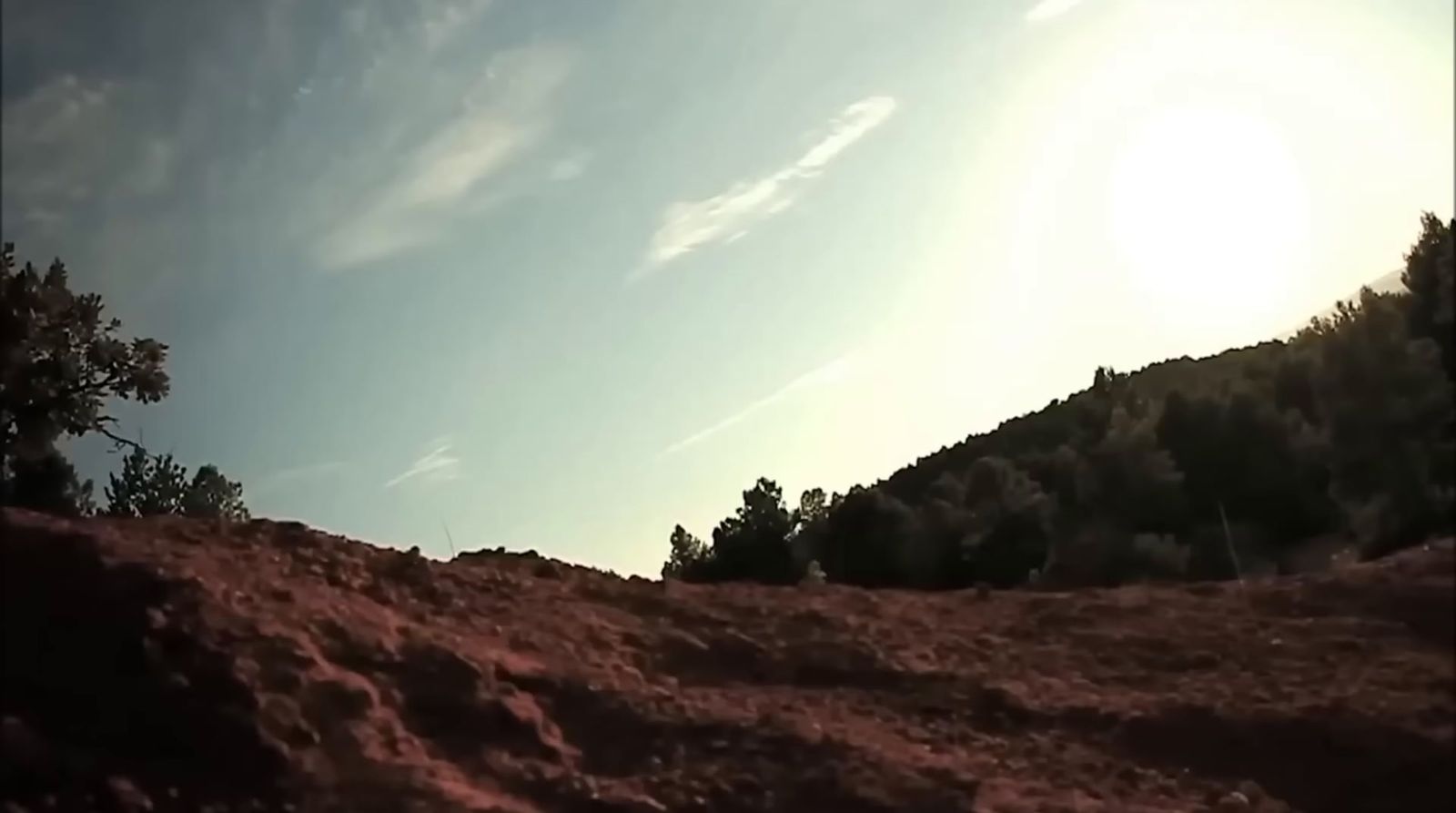 a person riding a skateboard down a hill