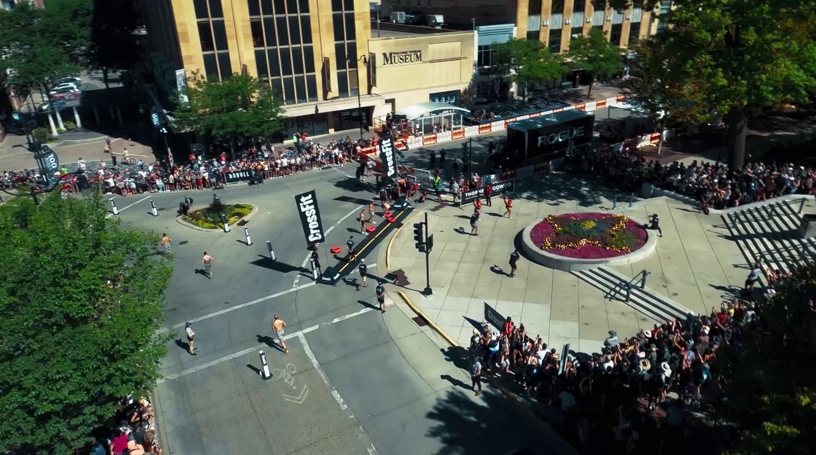 a crowd of people standing on a street corner