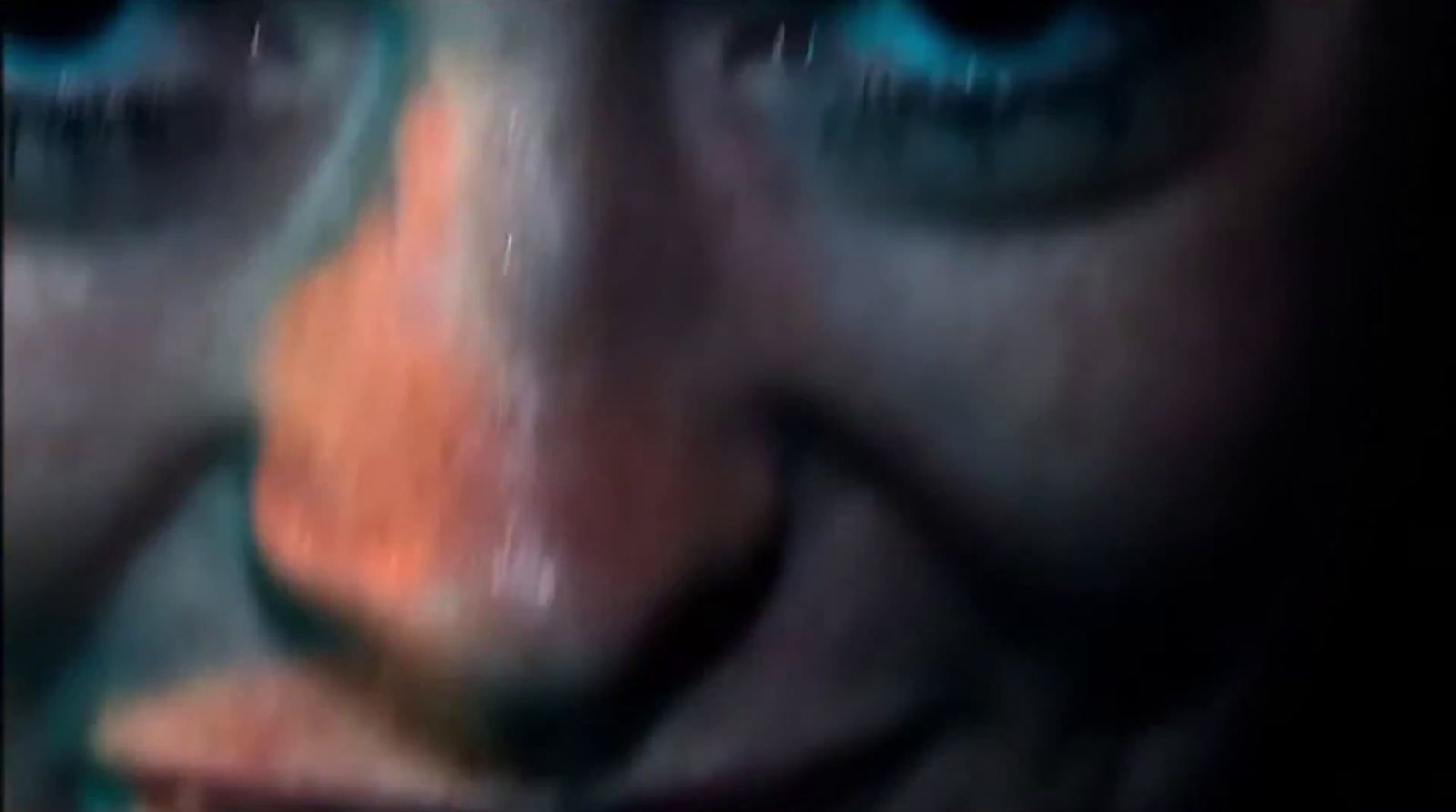 a blurry image of a woman's face with blue eyes