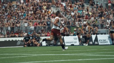 a man running across a field with a soccer ball