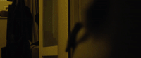 a blurry photo of a person standing in front of a door