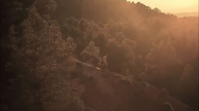 a person riding a snowboard down a hill