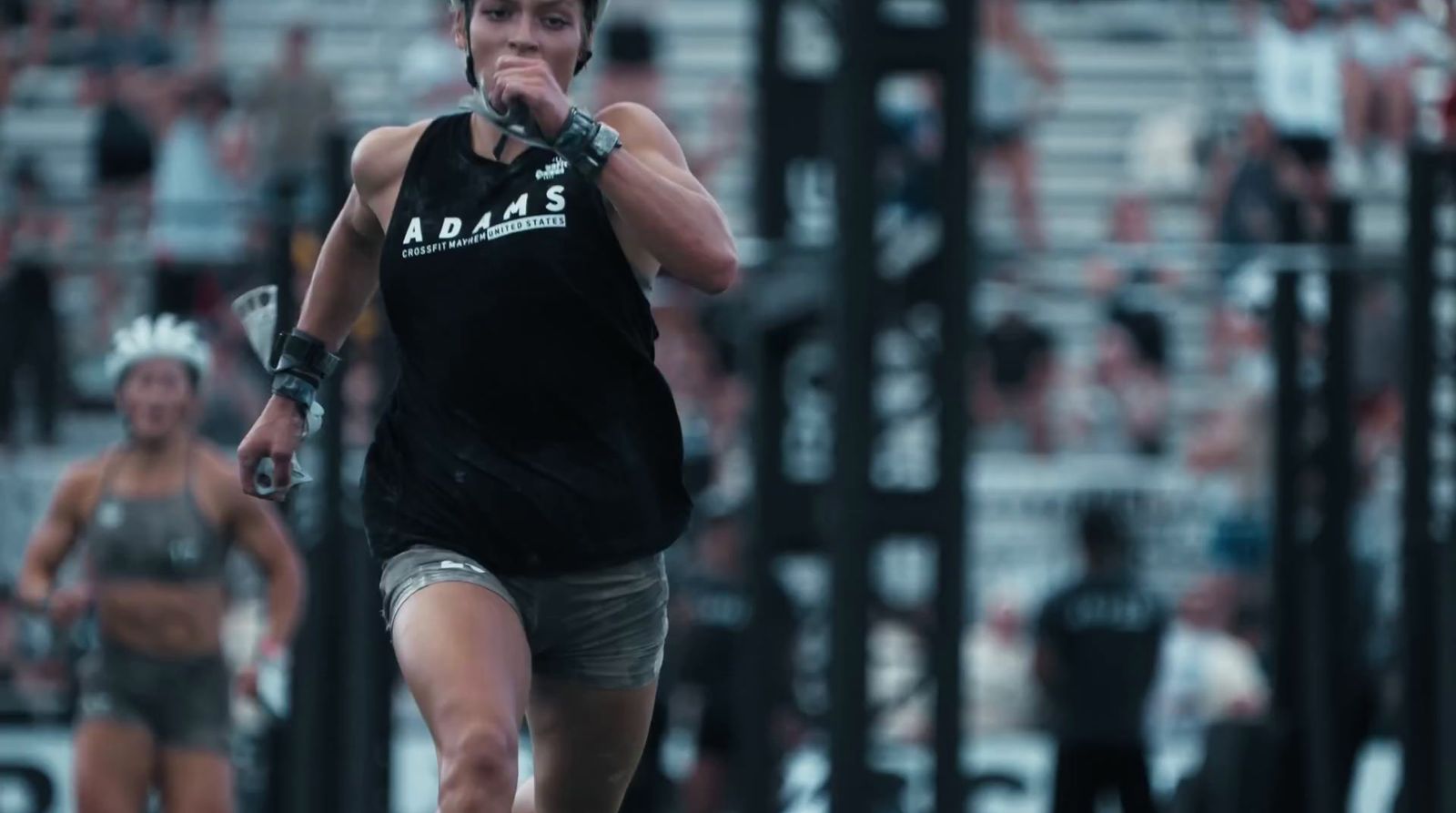 a woman in a black shirt and shorts holding a baseball bat