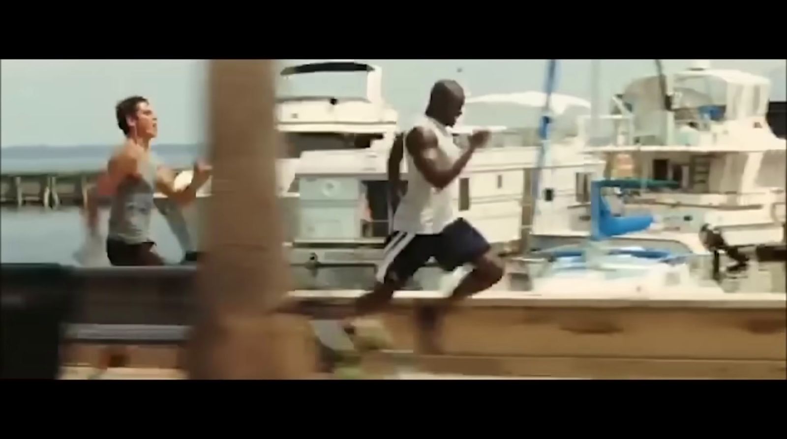 a man running on a dock next to a boat