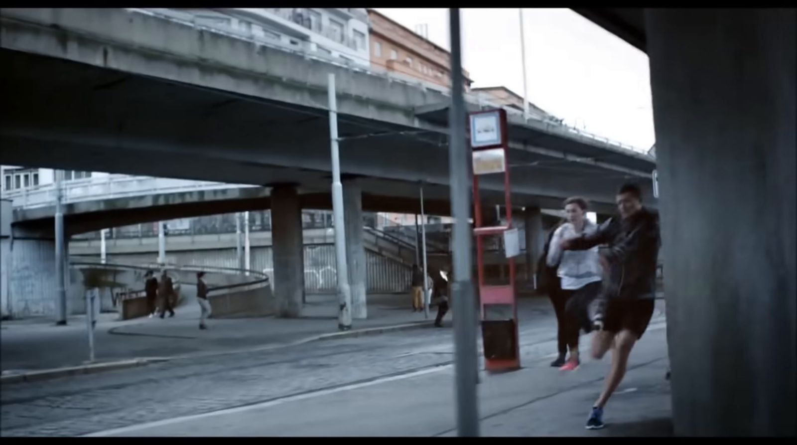 a couple of people that are walking down a street