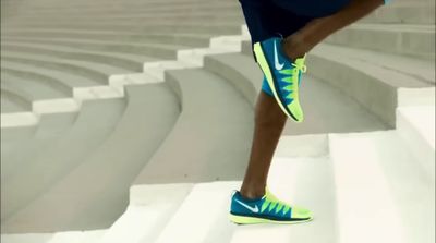 a close up of a person wearing running shoes