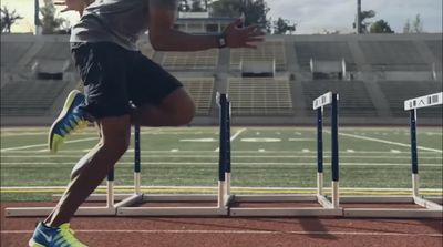 a man running on a track in a stadium