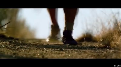 a close up of a person's feet walking on a path