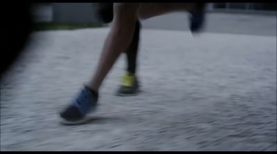 a blurry photo of a person's legs and shoes