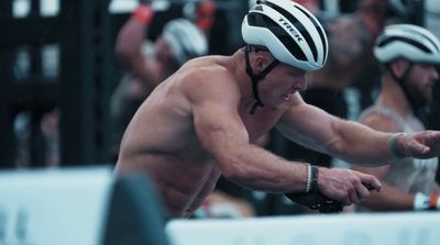 a shirtless man riding a bike in a race