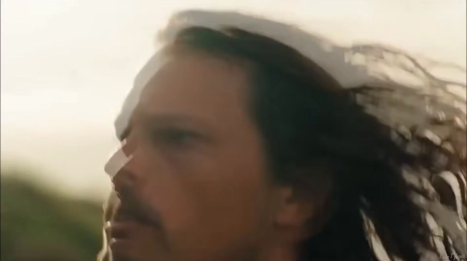 a blurry photo of a man with long hair