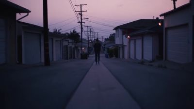 a person walking down a street at night