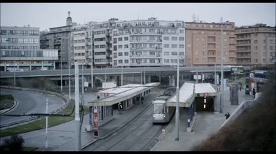 a train traveling down tracks next to tall buildings