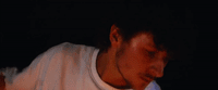 a blurry image of a man in a white shirt