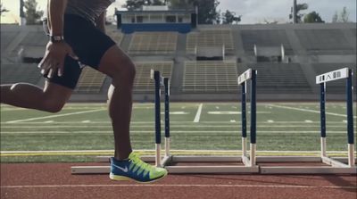 a man running on a track in a stadium