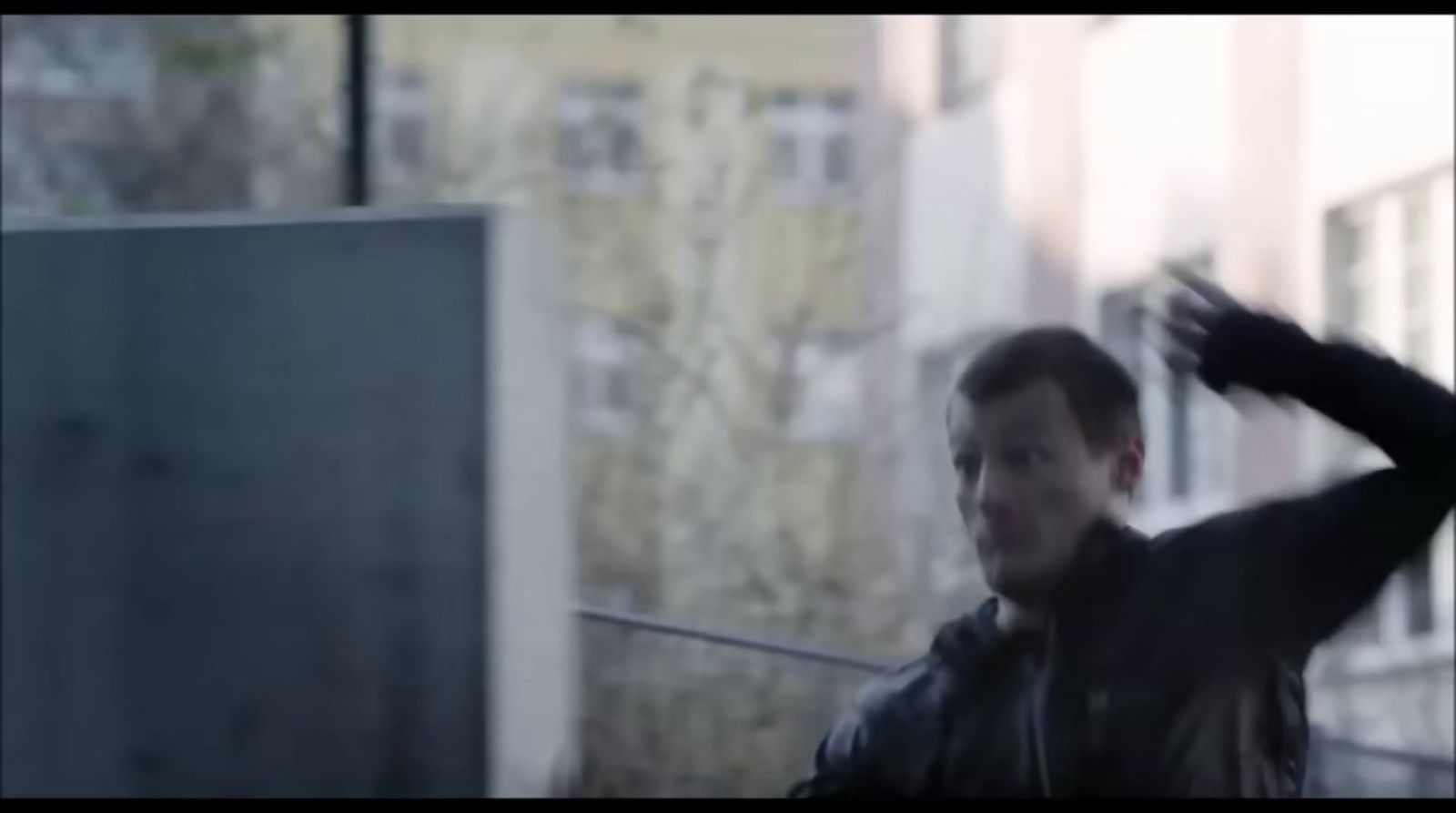 a blurry image of a man in a leather jacket