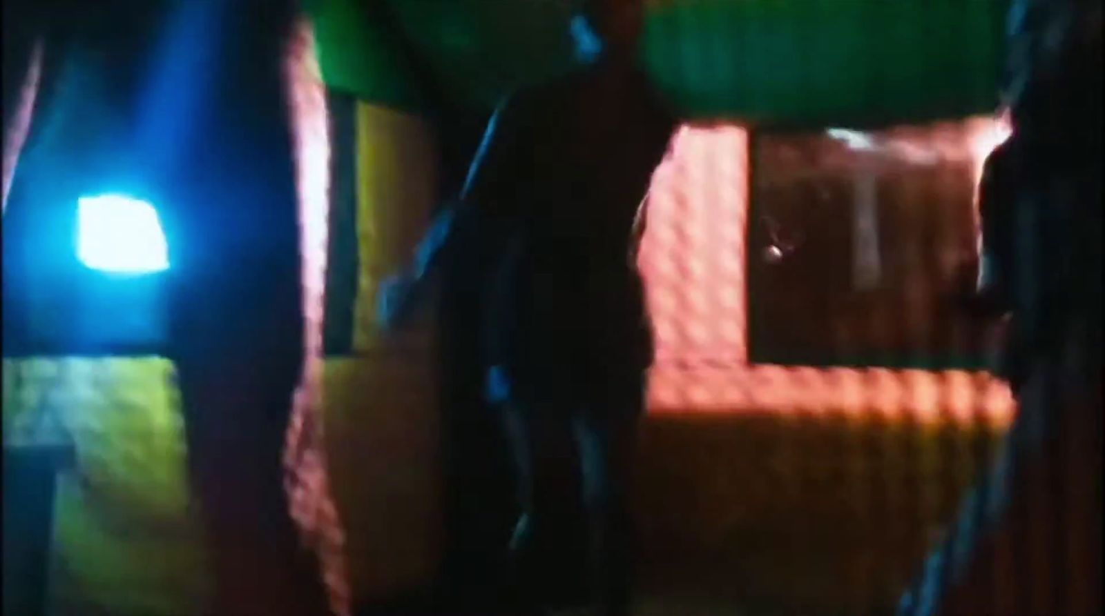 a blurry image of a man standing in a room