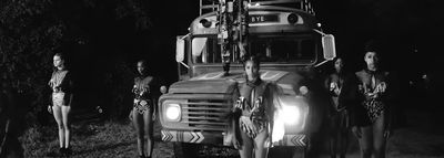 a group of people standing next to a large truck