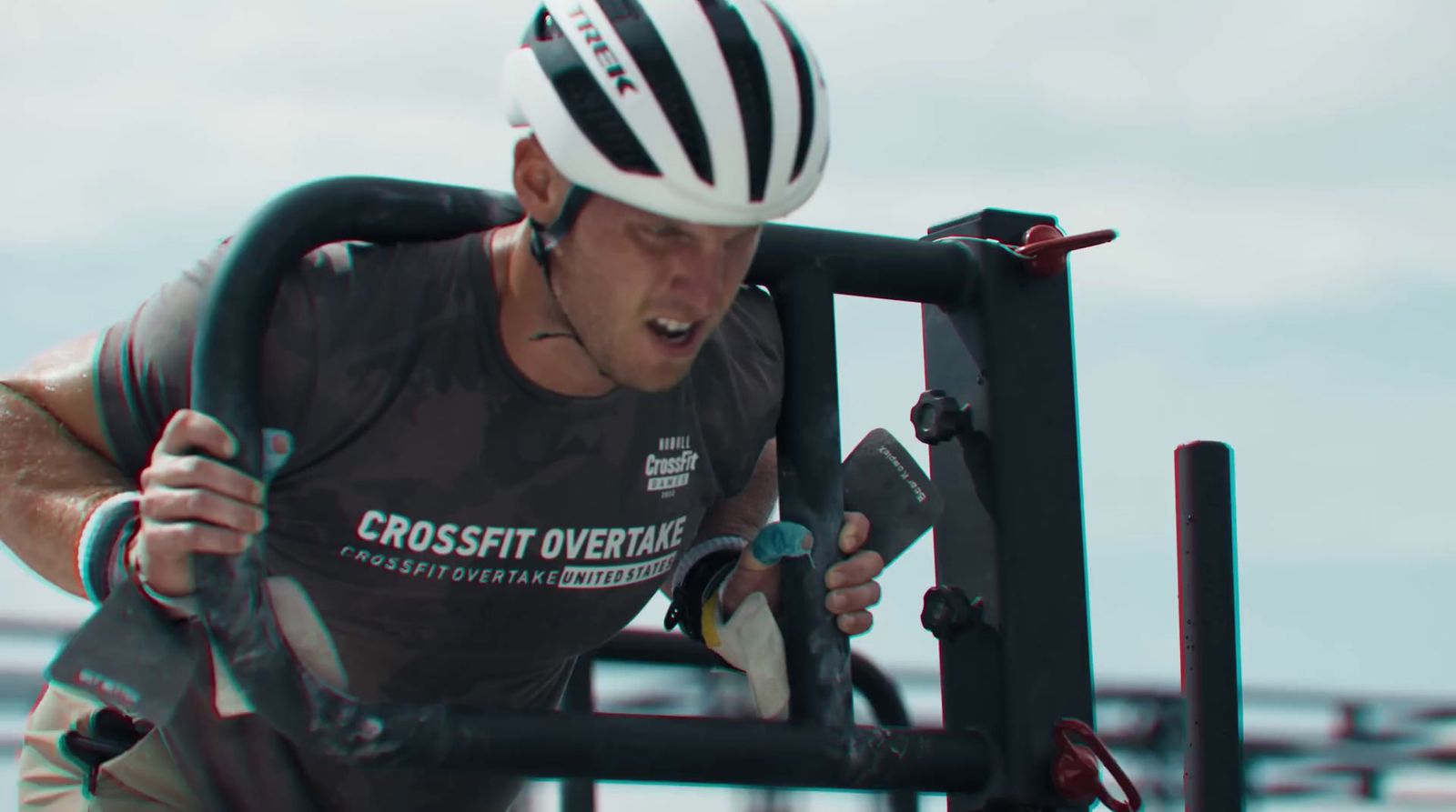 a man wearing a helmet and holding onto a bike rack