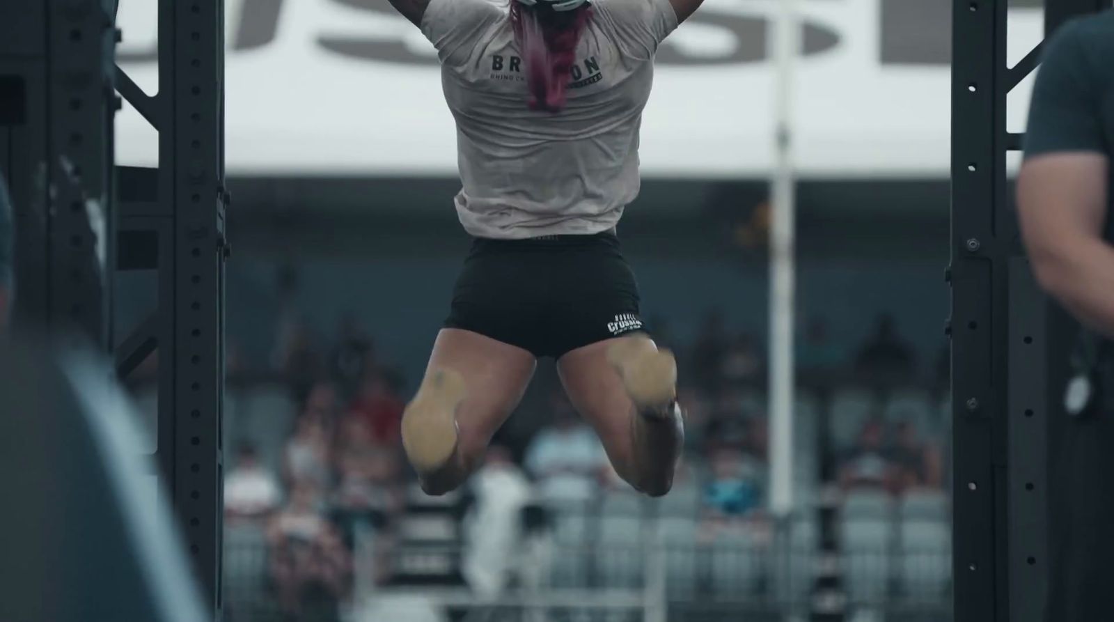 a person jumping in the air in a gym