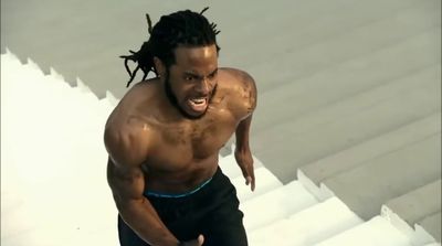 a man with dreadlocks running down a flight of stairs