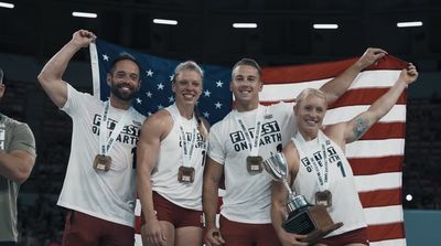 a group of men and women holding up a flag