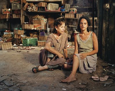 a couple of women sitting on the ground