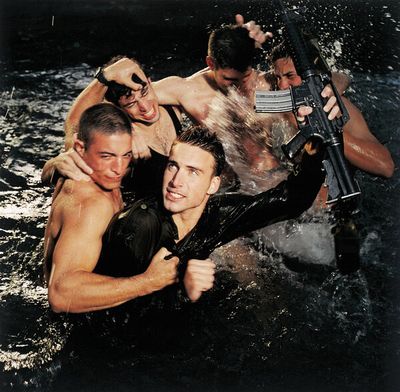 a group of men in the water with guns