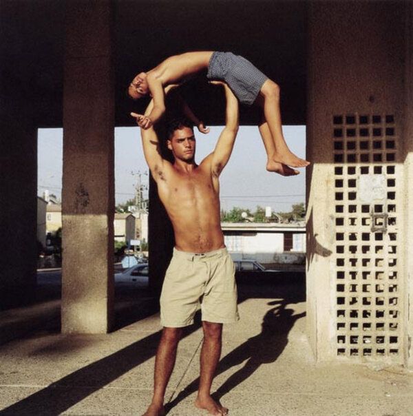 a man is doing a handstand on another man