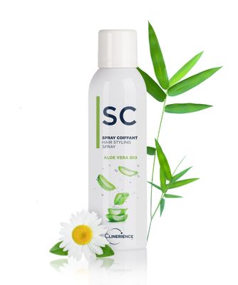 a bottle of shampoo next to a flower