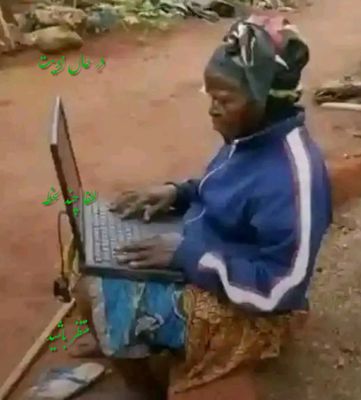 a woman sitting on a bench using a laptop computer