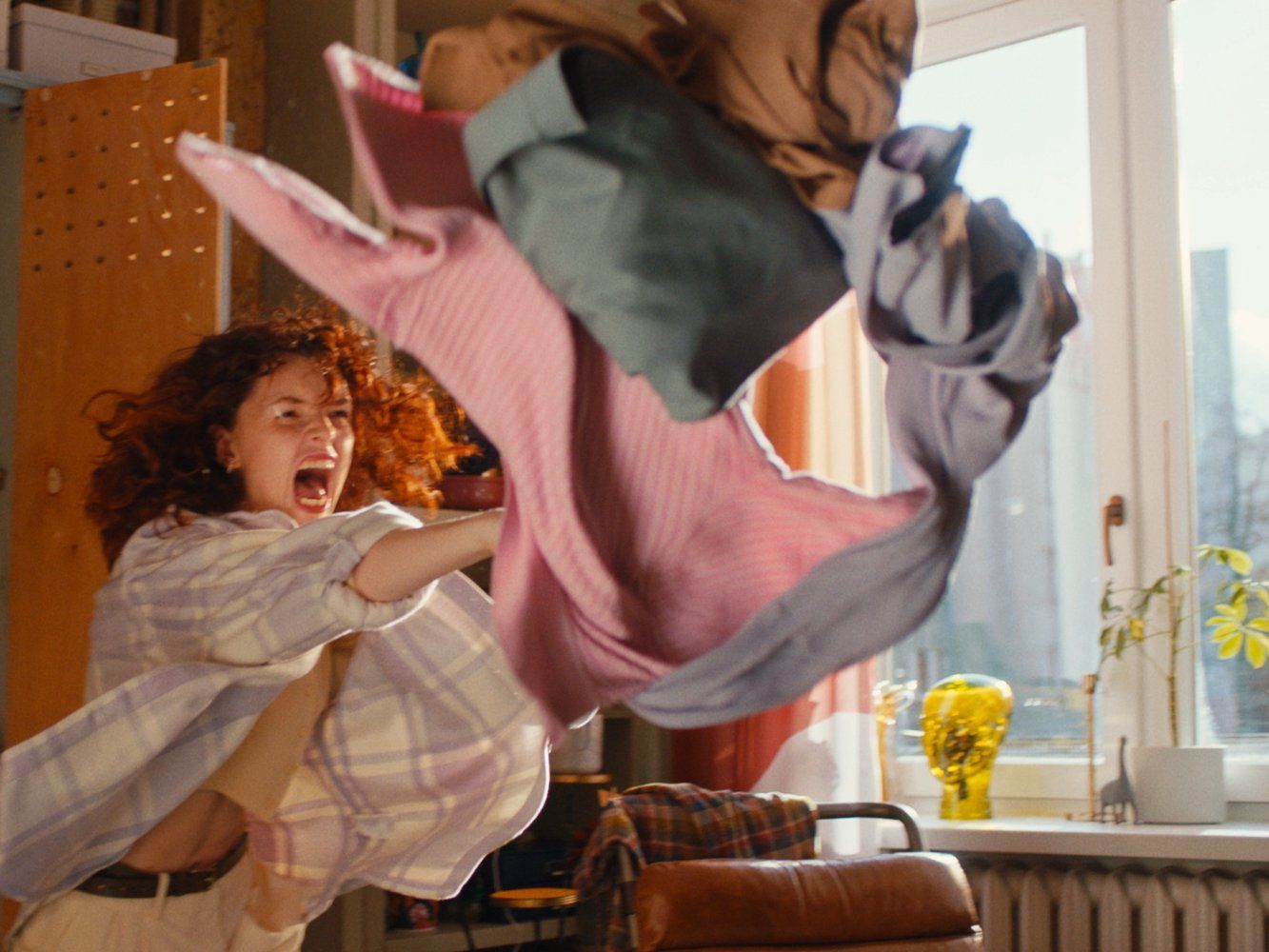 a woman in a room with a large object in the air