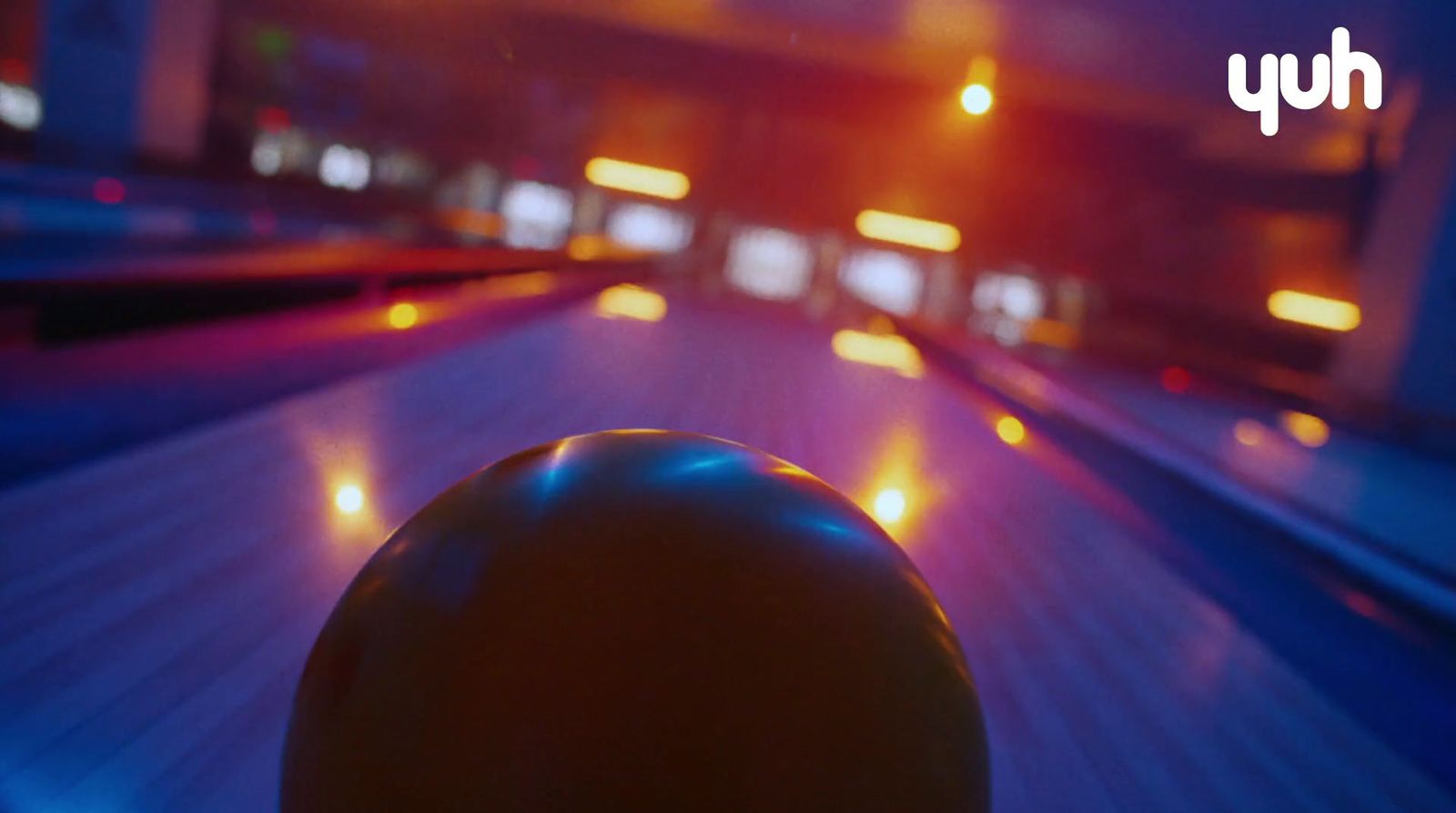 a bowling ball sitting on top of a bowling alley