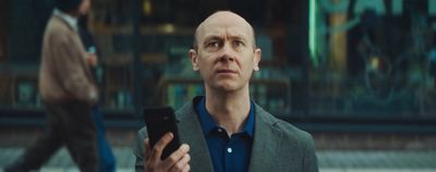 a man holding a cell phone in his hand