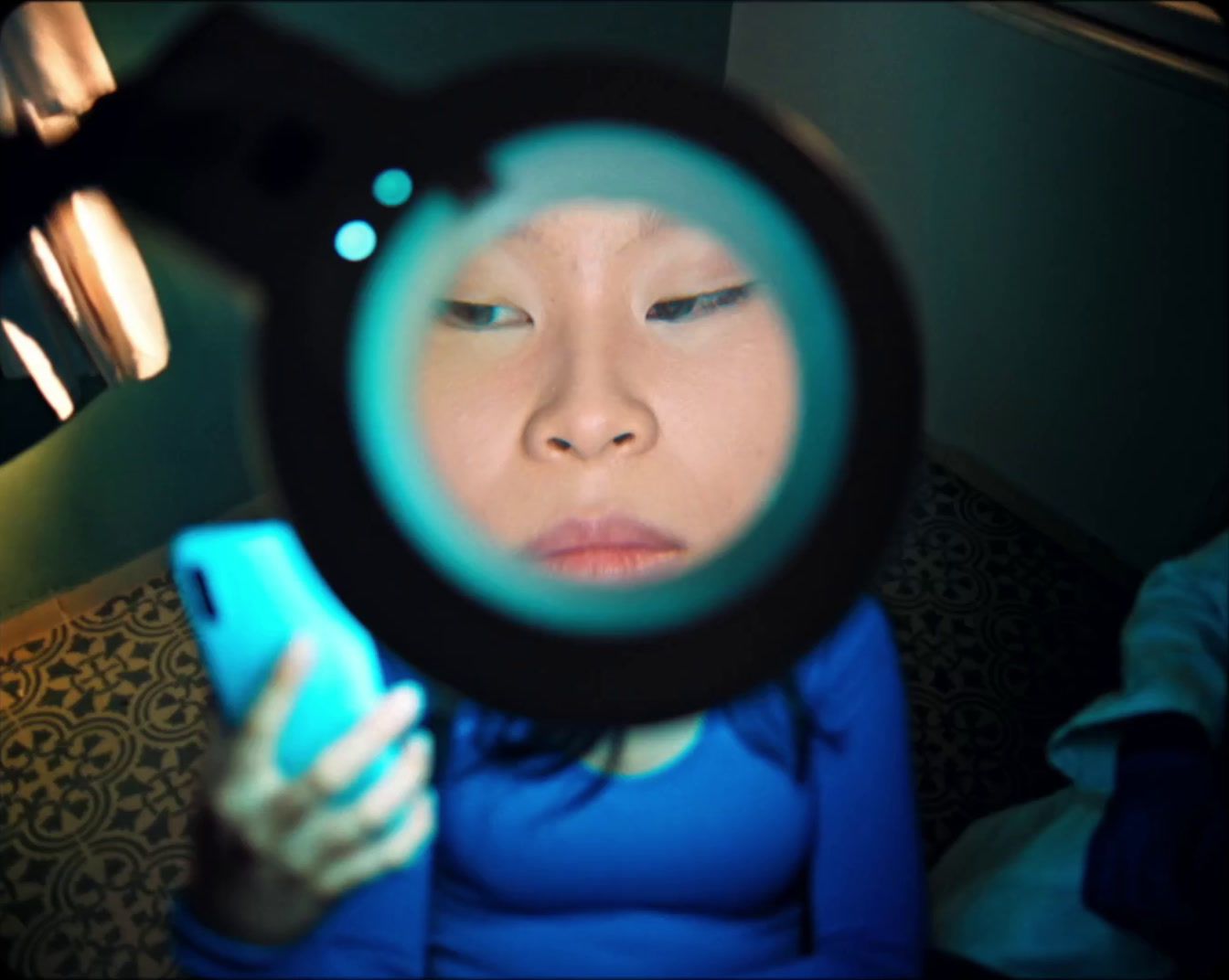 a woman looking through a magnifying glass