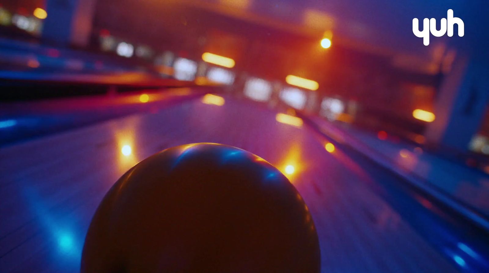 a bowling ball sitting on top of a bowling alley