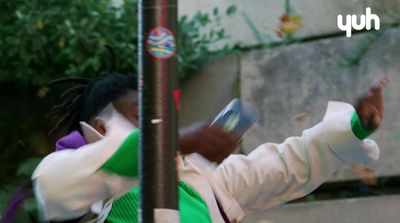 a woman in a green and white outfit holding a cell phone