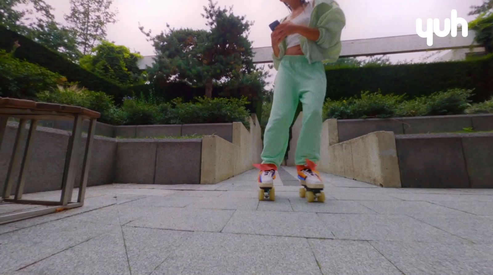 a man riding a skateboard down a sidewalk