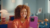 a woman with curly hair sitting in a room