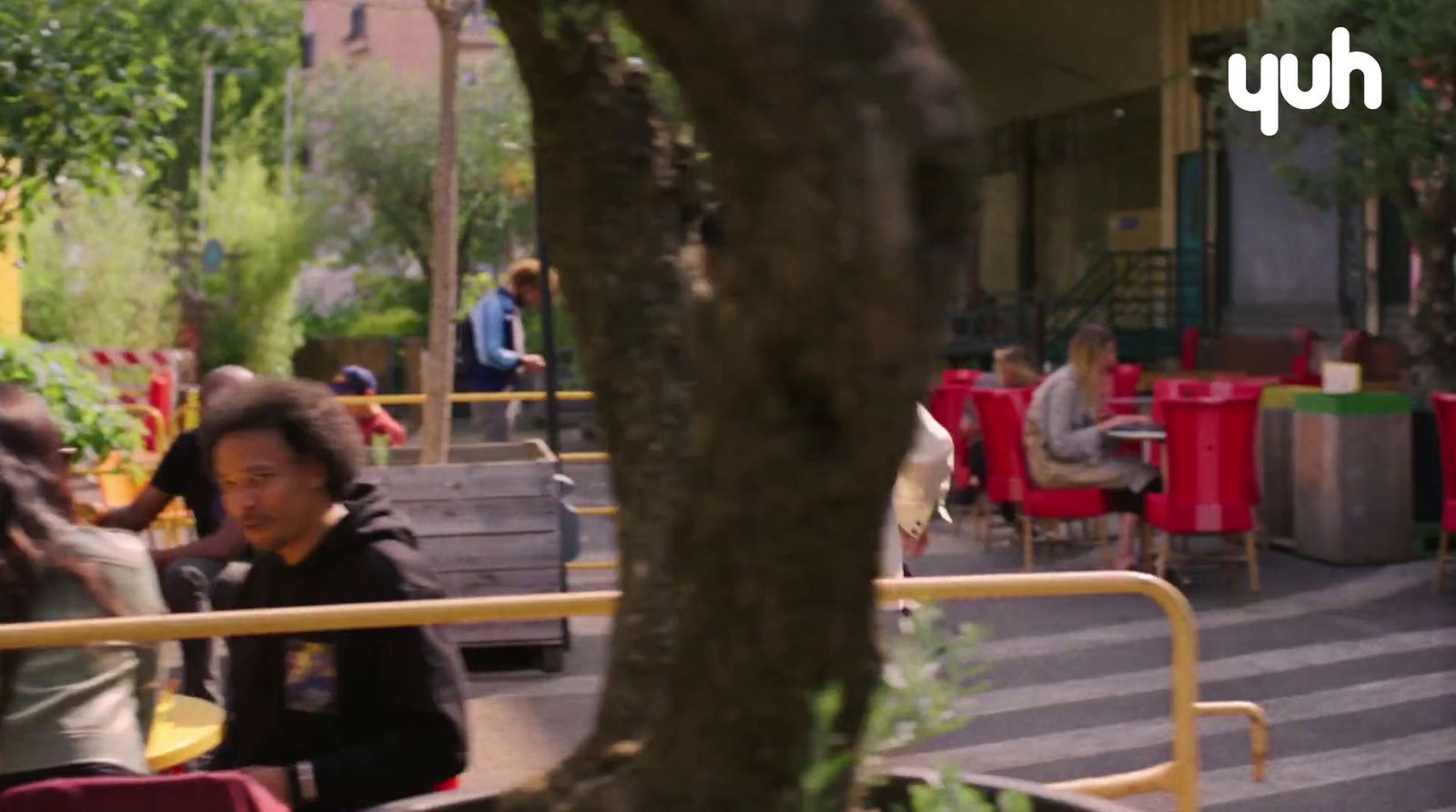 a group of people sitting at a table outside