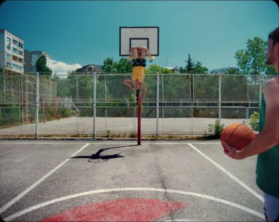 a man standing on a basketball court holding a basketball