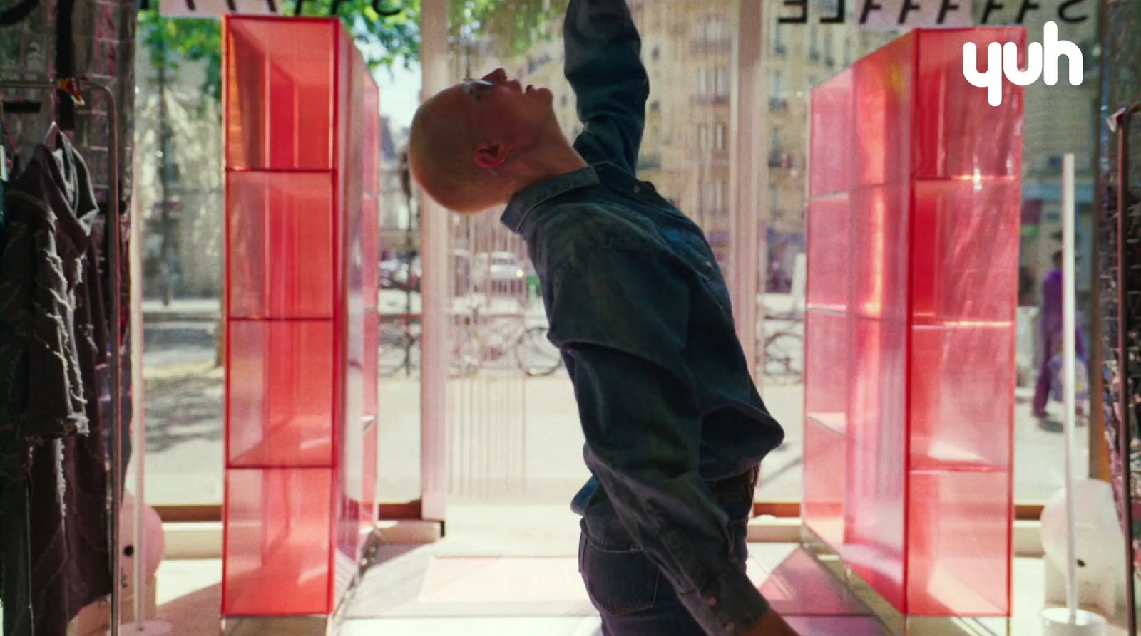 a young boy standing in front of a red display case